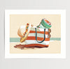 Beach bag filled with towel, sunglasses, and sun hat on the sand with ocean in the background, coastal lifestyle art print

