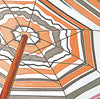 Colorful beach umbrellas viewed from below against a bright blue sky, coastal art print displayed in detail