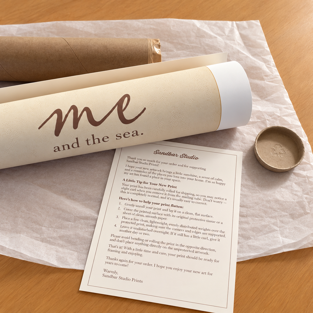 Sandbar Studio Prints coastal art print rolled in protective packaging beside a kraft mailing tube, with a personalized thank-you card and print-flattening instructions on a wooden table.